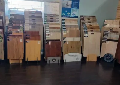 Interior of a flooring store with various wood floor samples displayed on stands