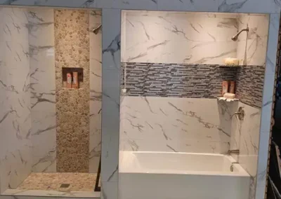 modern bathroom with marble walls and a bathtub with mosaic tile feature